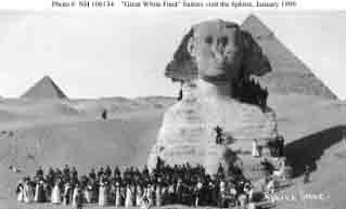 Sailors pose at the Sphinx with their guides during sightseeing tour to Giza, Egypt, January 1909.