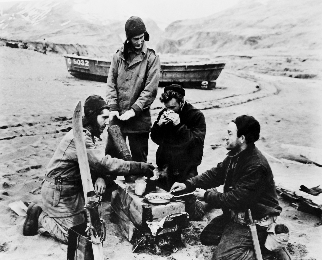 LC-Lot-803-26:  Aleutian Islands Campaign, June 1942 - August 1943.   Battle of Attu, May 11-29, 1943.   Allied Landing on Attu Island, May 11 1943.   The Chow Was Hot, The Company Congenial.  There was nothing fancy about this meal prepared by sailors in the Holtz Bay area on May 19, but the food was hot.  Note the ski standing upright in the foreground.  Snow can be found year round on Attu Island.  U.S. Navy photograph, released May 29, 1943.   Photographed through Mylar sleeve.  Courtesy of the Library of Congress.  (2015/11/06).