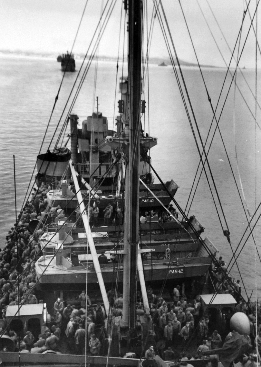 LC-Lot-803-27:  Aleutian Islands Campaign, June 1942 - August 1943.   Battle of Attu, May 11-29, 1943.   Deck of Attu-Bound Transport Crowded.  Across the crowded deck of an Attu-bound transport, USS Heywood (APA-6), stretching off into the distance can be seen other ships in the convoy, which carried the fight to the Japanese.  Note the Landing Craft, Vehicle, Personnel  (LCVPs).   U.S. Navy photograph, released May 29, 1943.   Photographed through Mylar sleeve.  Courtesy of the Library of Congress.  (2015/11/06).