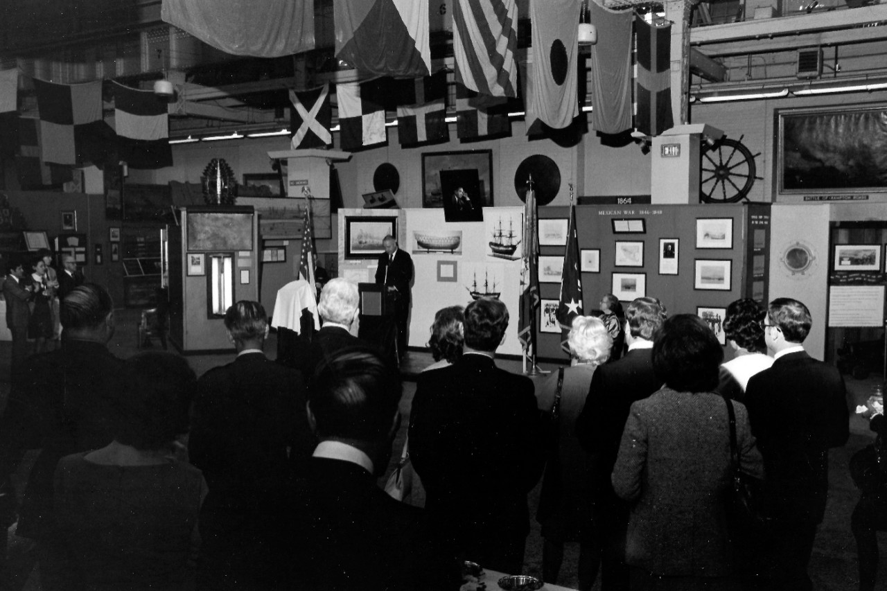 NMUSN-134: Presentation of HMS Intrepid Silver Tray, April 1975. Secretary of the Navy J. William Middendorf is giving remarks. Shown: Guests attend the presentation at the Navy Memorial Museum, April 18, 1975. National Museum of the U.S. Navy Ph...