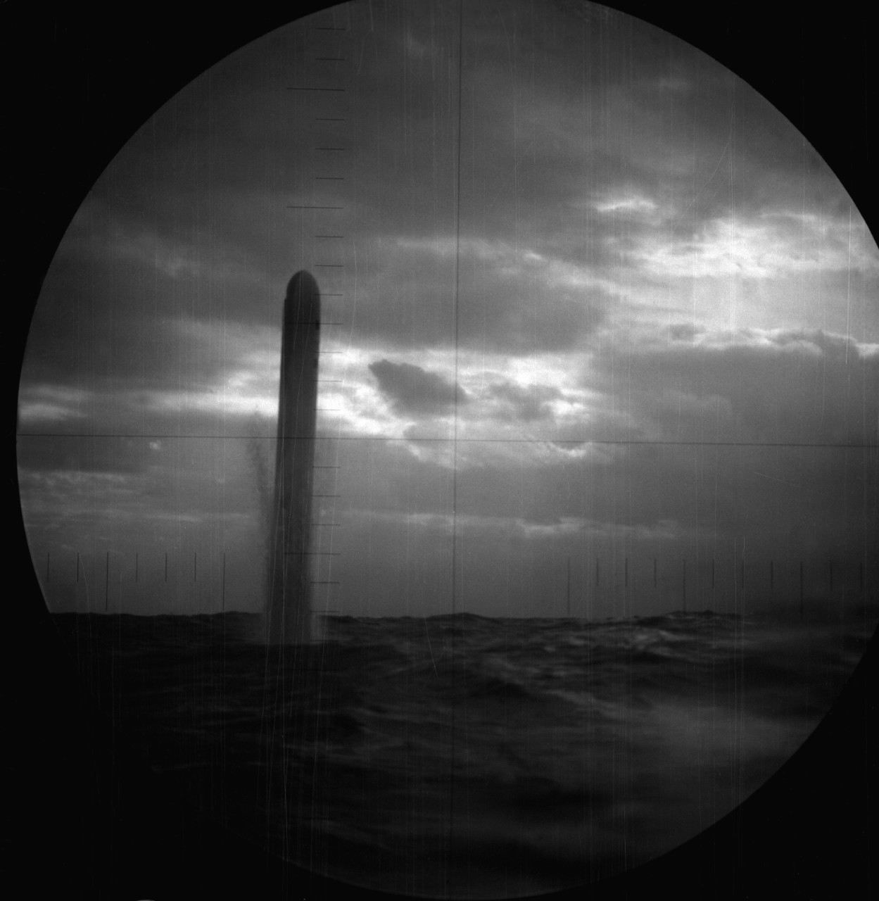330-CFD-DN-SN-91-08884: BGM-109 Tomahawk land attack missile (TLAM), Operation Desert Storm, 1991. As seen through USS Pittsburgh’s (SSN-720) periscope and targeted on an Iraqi position. It begins to leave the water following a vertical launch tu...