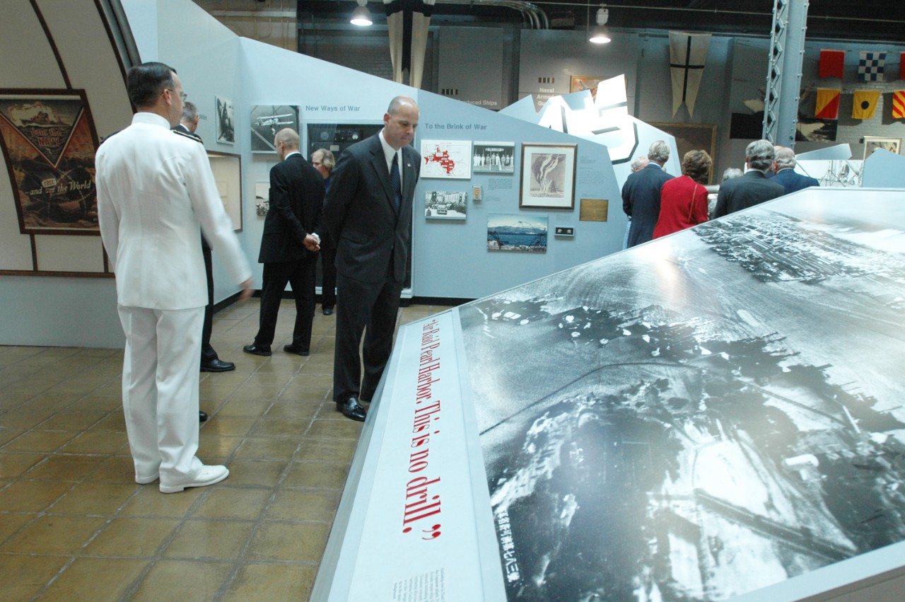 050919-N-23838-274: Washington Navy Yard, Washington, D.C. (September 19, 2005). His Majesty King Harald V of Norway is listening to a presentation in the Atlantic Section of In Harm’s Way (WWII Exhibit) given by Museum Director, Dr. Kim Nielsen....