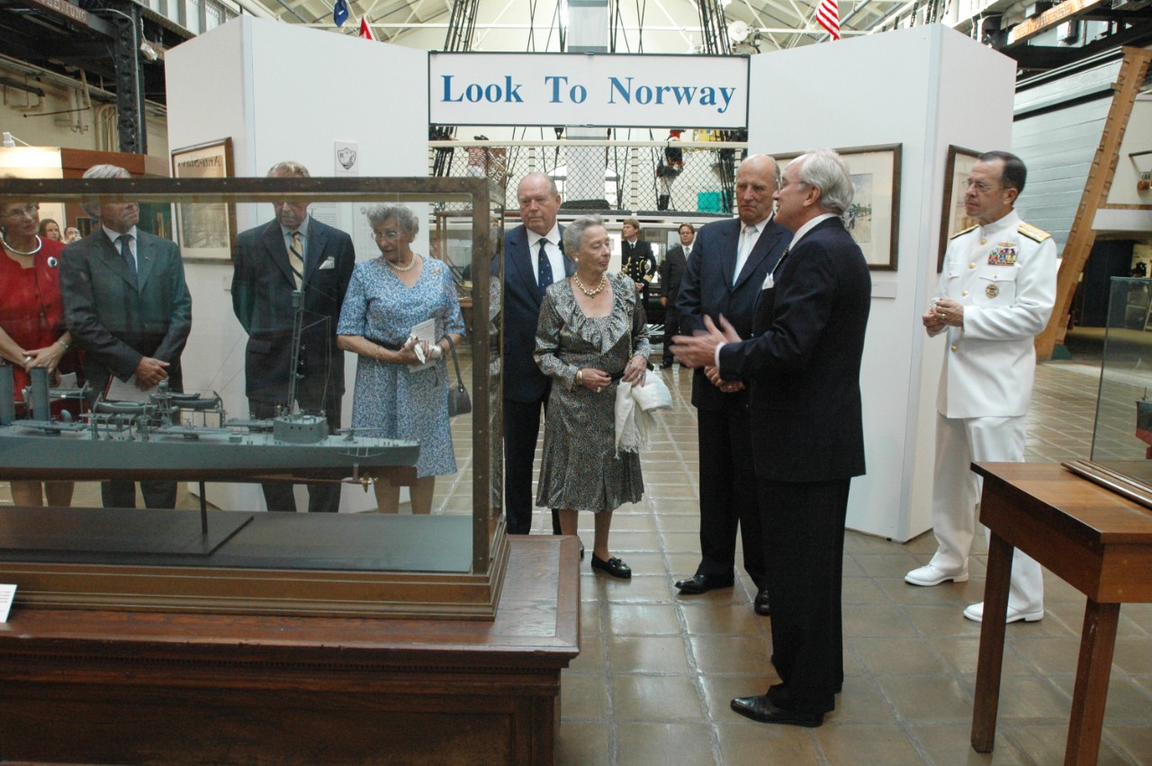 050919-N-23838-242: Washington Navy Yard, Washington, D.C. (September 19, 2005). His Majesty King Harald V of Norway, third from right, looks at the Look to Norway exhibit done in honor of his visit at the Navy Museum located at the Yard. Giving ...