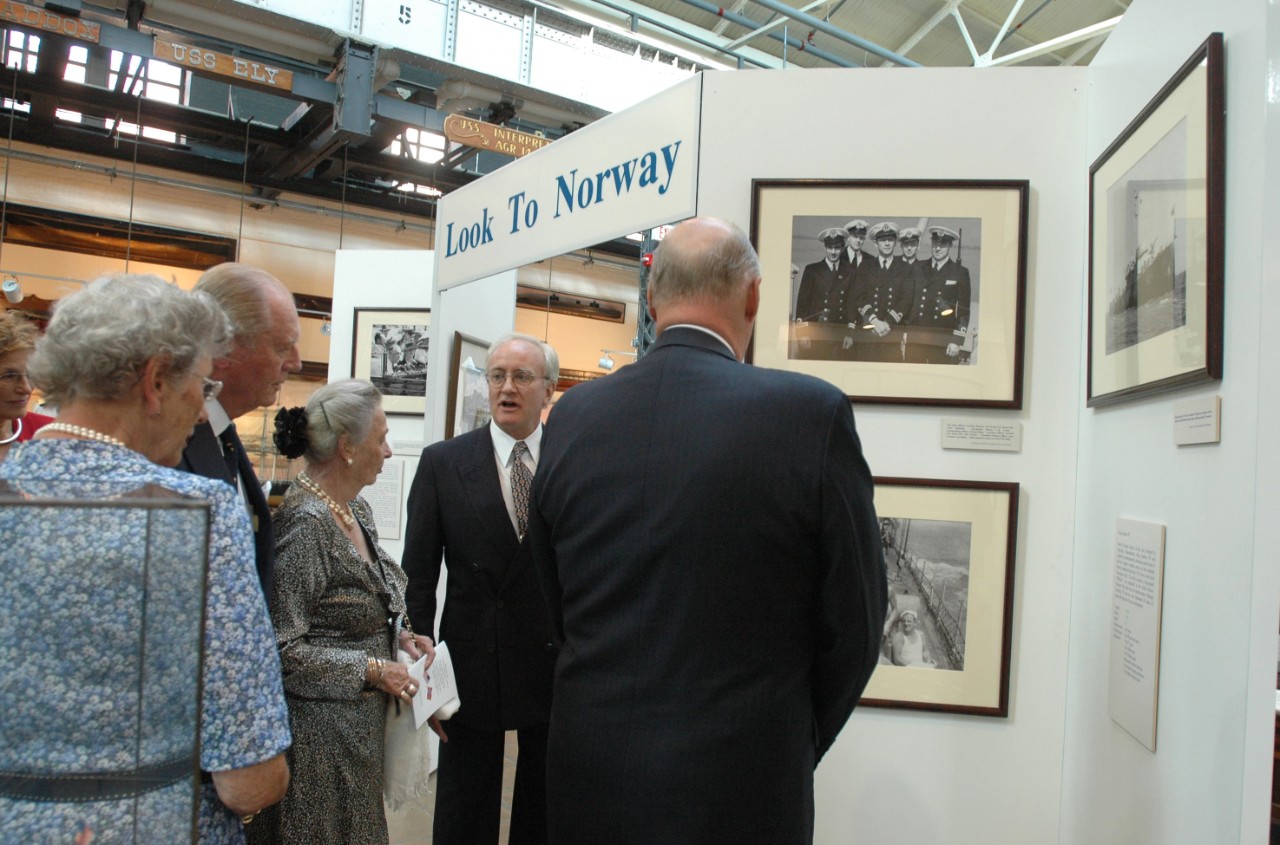 050919-N-23838-200: Washington Navy Yard, Washington, D.C. (September 19, 2005). His Majesty King Harald V of Norway, far right, looks at the Look to Norway exhibit done in honor of his visit at the Navy Museum located at the Yard. Giving an intr...