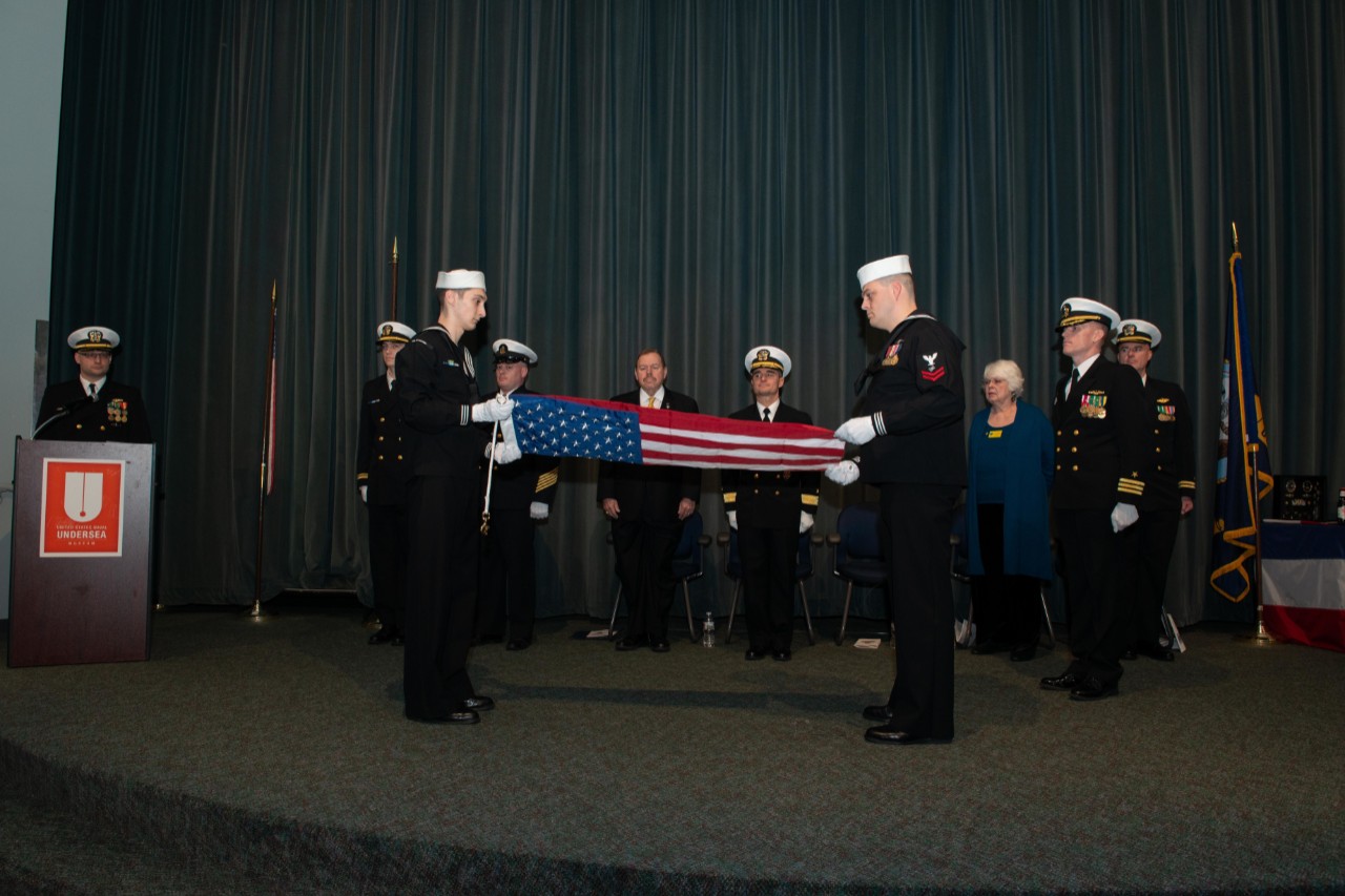 200117-N-WJ386-1057 KEYPORT, Wash. (Jan. 17, 2020) Sailors assigned to the Los Angeles-class fast-attack submarine USS Pittsburgh (SSN 720) fold the boat's ensign during an inactivation ceremony at the U.S. Naval Undersea Museum in Keyport, Washi...