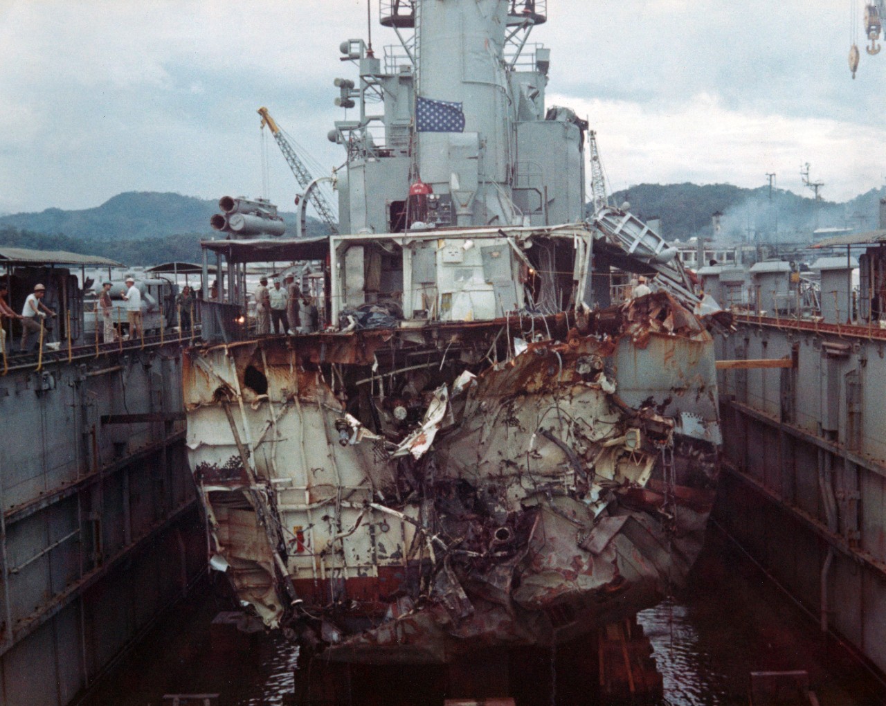 44 color negatives and 7 color prints showing the damaged USS Frank E. Evans (DD-754) being escorted to the auxiliary repair drydock USS Windsor (ADR-22) at Subic Bay, after it had been in involved in a collision with the Australian aircraft carr...