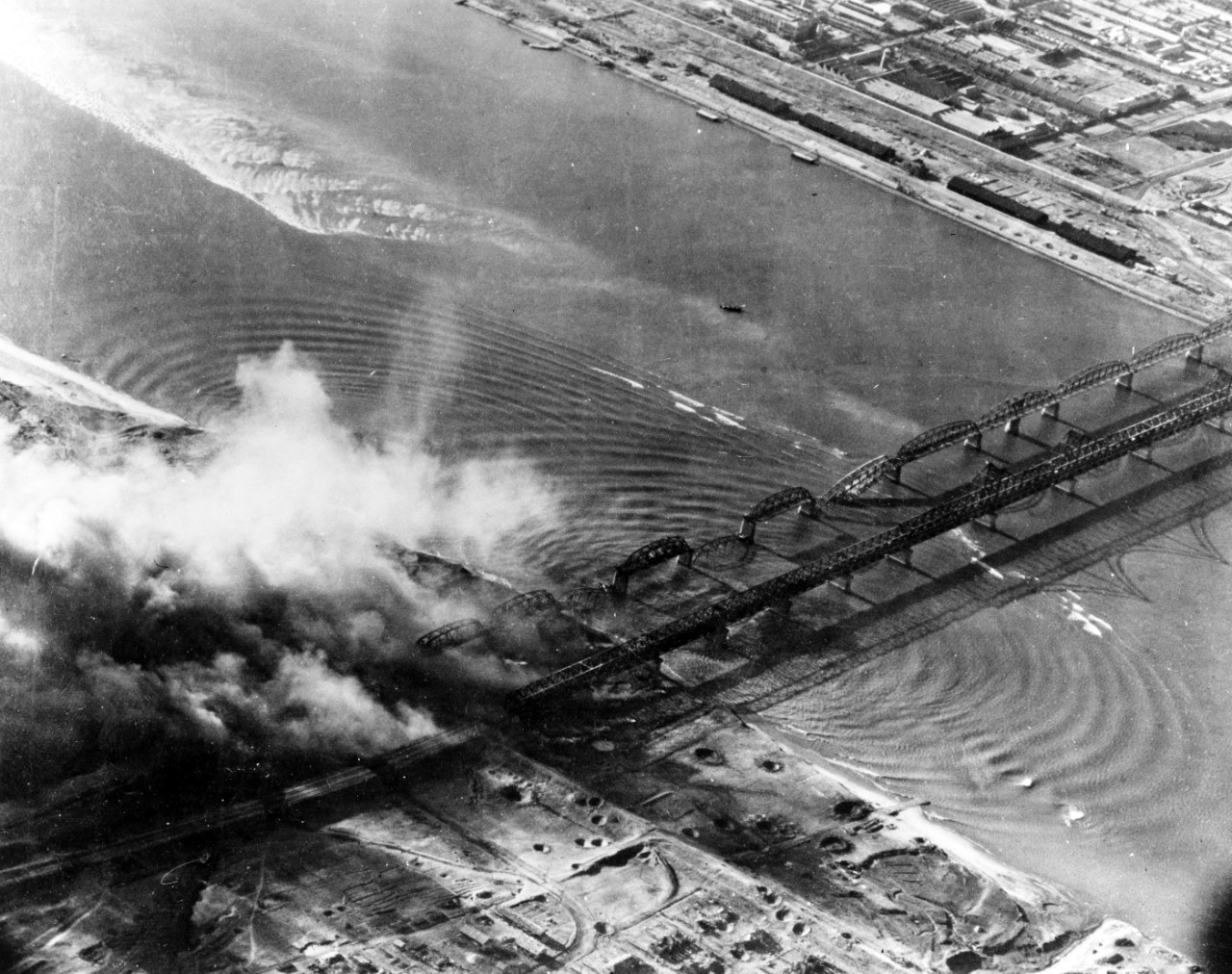 aerial black and white photo of attack of bridges by naval aviators