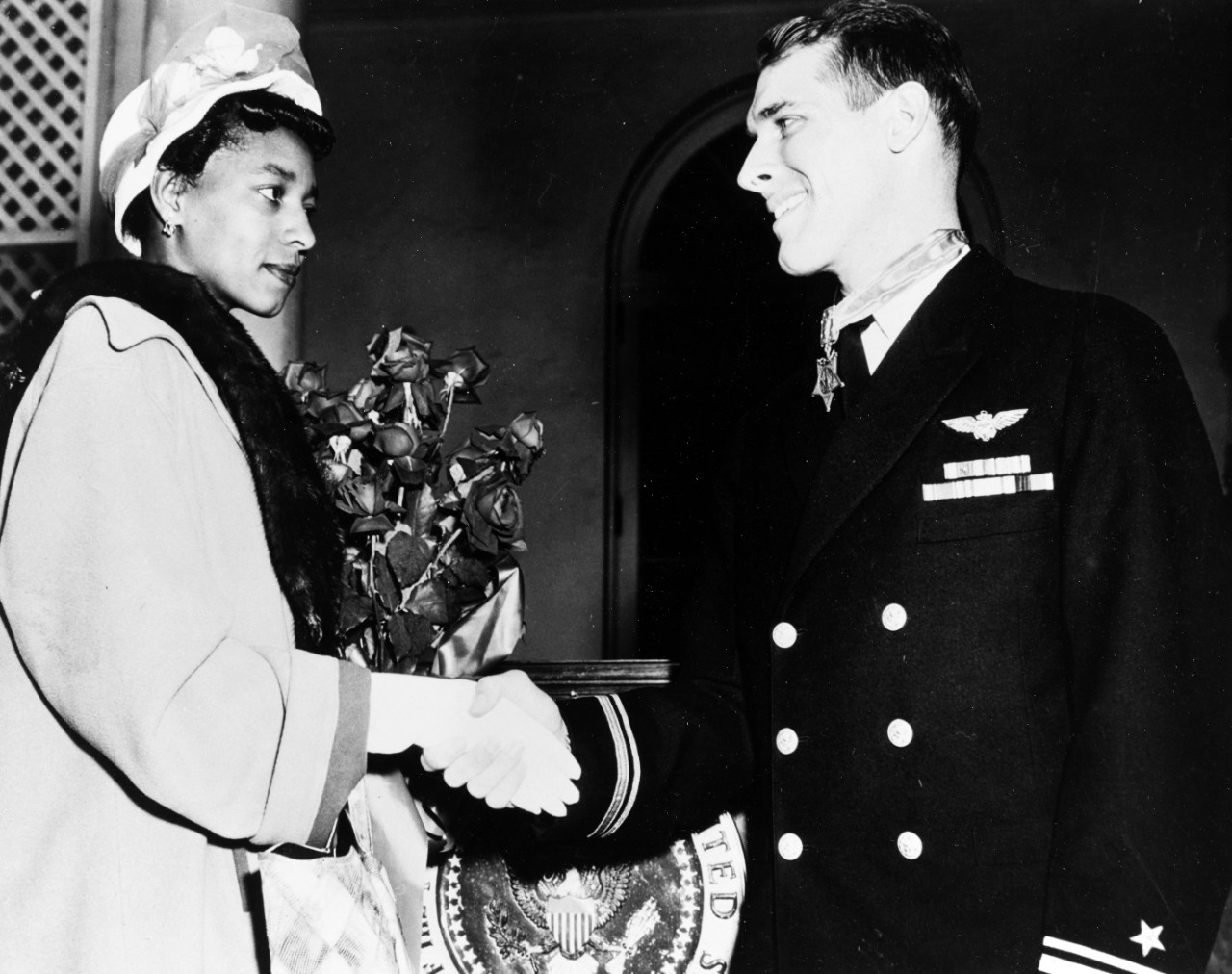 Hudner shaking hands with Ensign Brown's widow