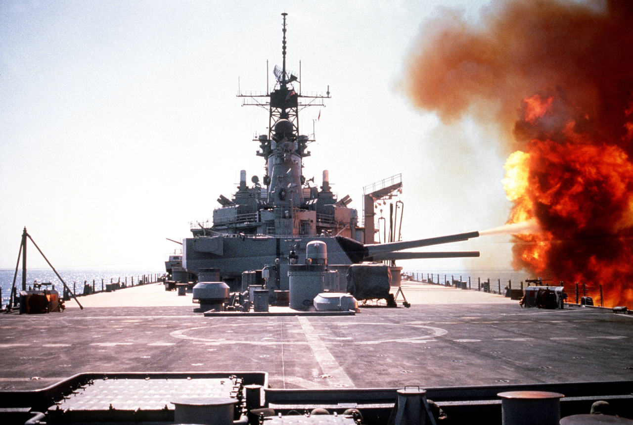 The battleship USS Wisconsin (BB-64) fires a round from one of the Mark 7 16-inch/50-caliber guns in its No. 3 turret during Operation Desert Storm. (National Archives Identifier: 6480274)