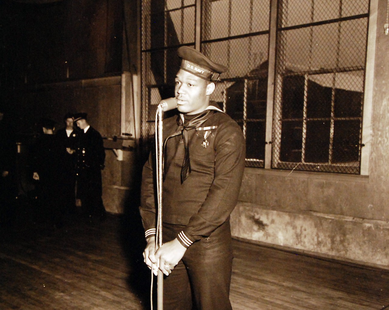 80-G-294808: Doris Miller, Mess Attendant First Class, USN. Speaking during a visit to the Naval Training Station, Great Lakes, Illinois, on 7 January 1943. 
