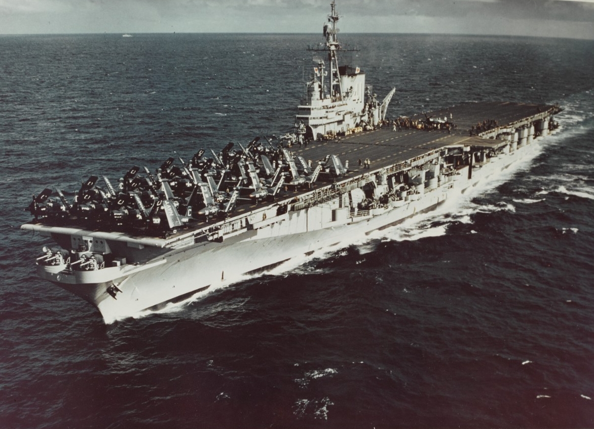 A carrier at sea with aircraft clearly visible on deck.