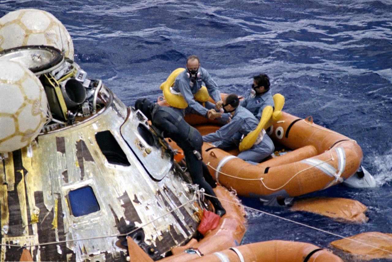 Navy Underwater Demolition Team swimmer assists the Apollo 12 crew during recovery operations