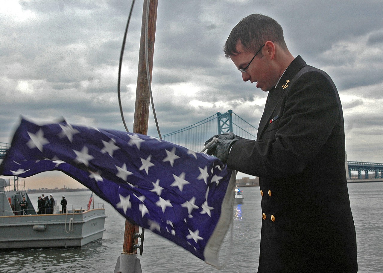 Midshipman 4th Class Nicholas D. Brockert raises the Union Jack aboard Yard Patrol Craft 691 (YP-691).