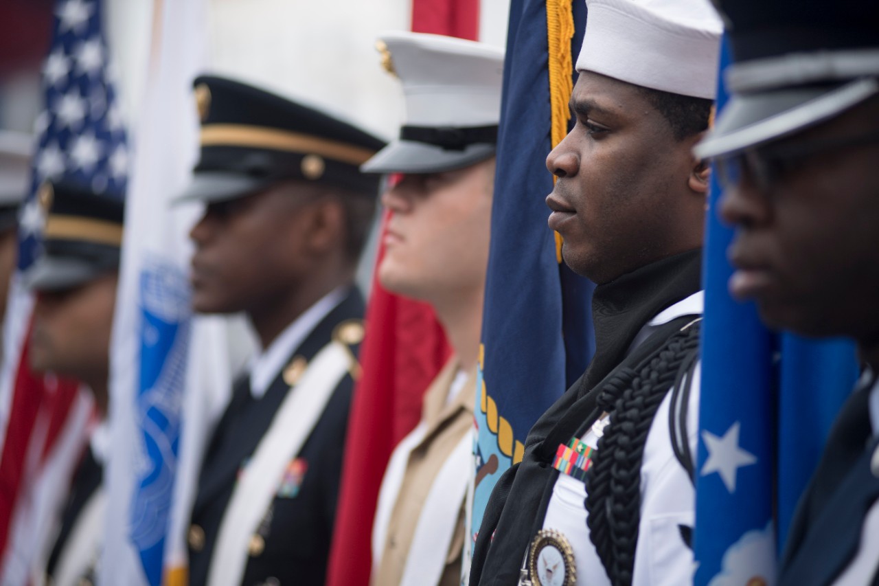 Members of a joint-service color guard stand by during a Memorial Day ceremony at the Intrepid Sea,