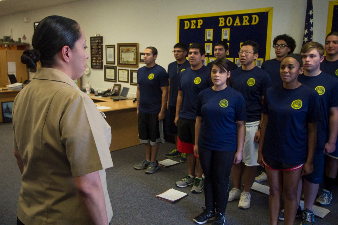 Aviation Boatswain's Mate (Equipment) 2nd Class Janel Banks, a recruiter assigned to Navy Recruiting District (NRD) Dallas, leads future Sailors in The Sailor’s Creed during a weekly Delayed Entry Program meeting.