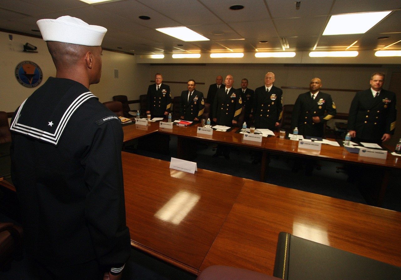 Command master chiefs from Naval Education and Training Command's (NETC) domain listen to Engineman 1st Class Sivenson Guerrier recite The Sailor’s Creed during his Sailor of the Year board.