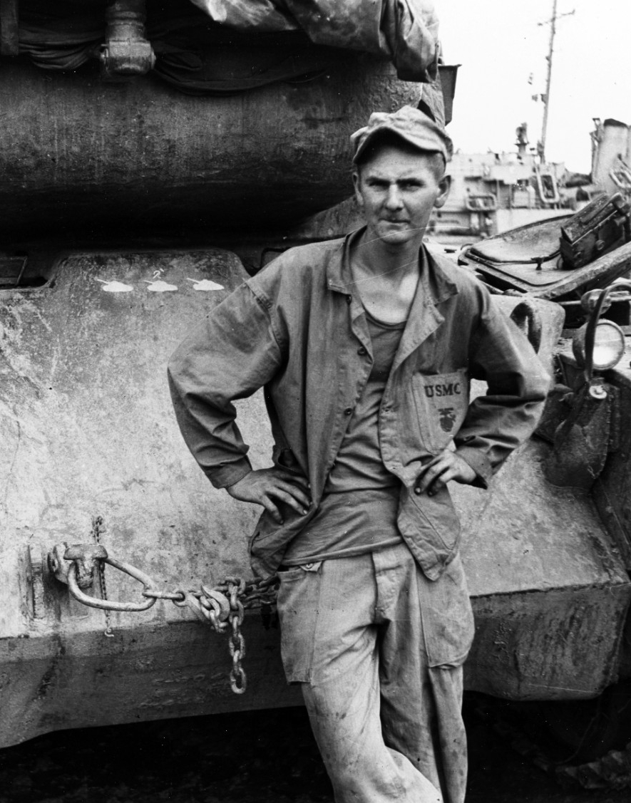 U.S. Marine stands by the front of a M-46 tank, which has three North Korean tank kills to its credit, on the Inchon waterfront