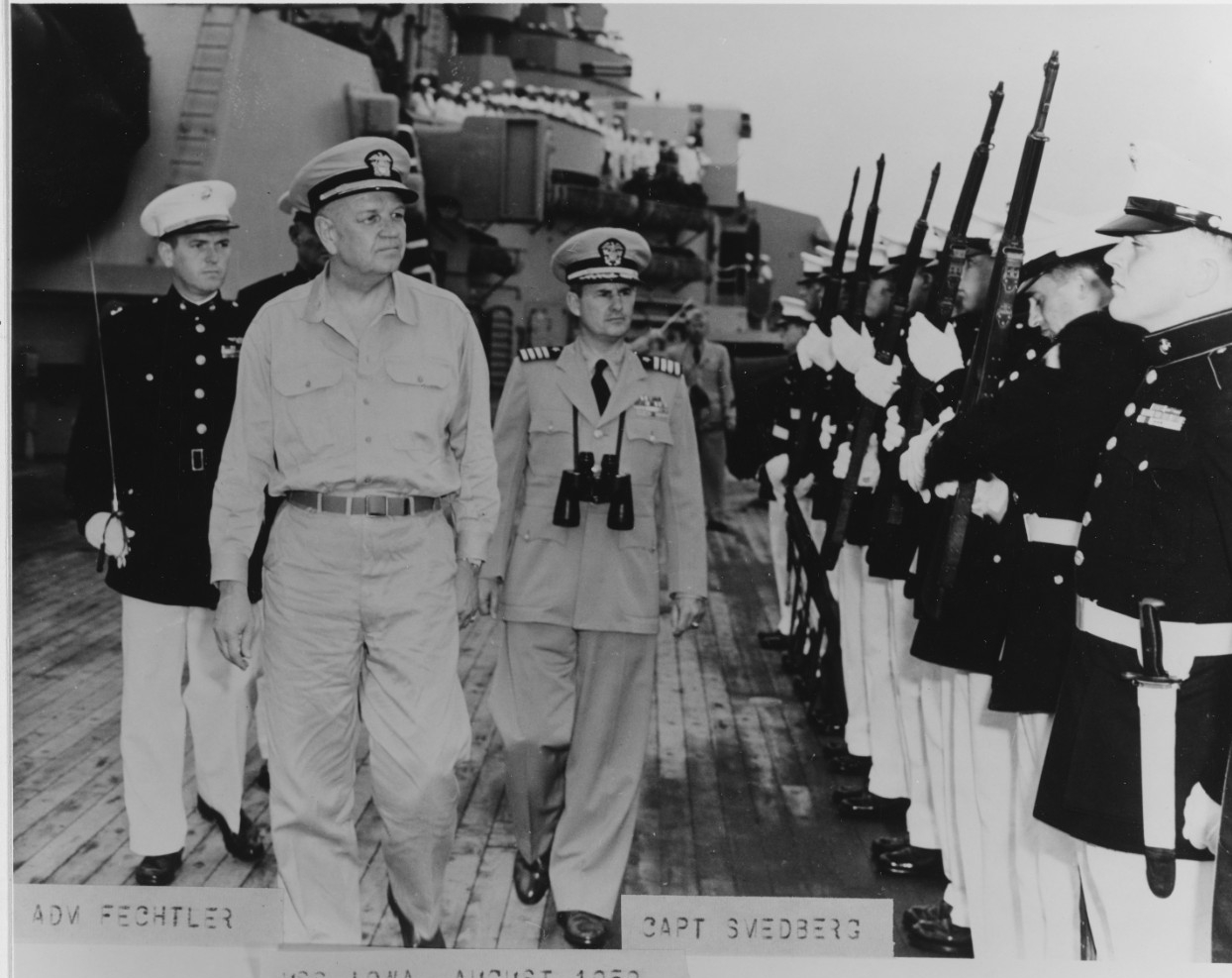 Admiral Fechteler is escorted by Captain William R. Smedberg III, while inspecting Marines aboard the USS Iowa in August 1952, off Wonsan, Korea.