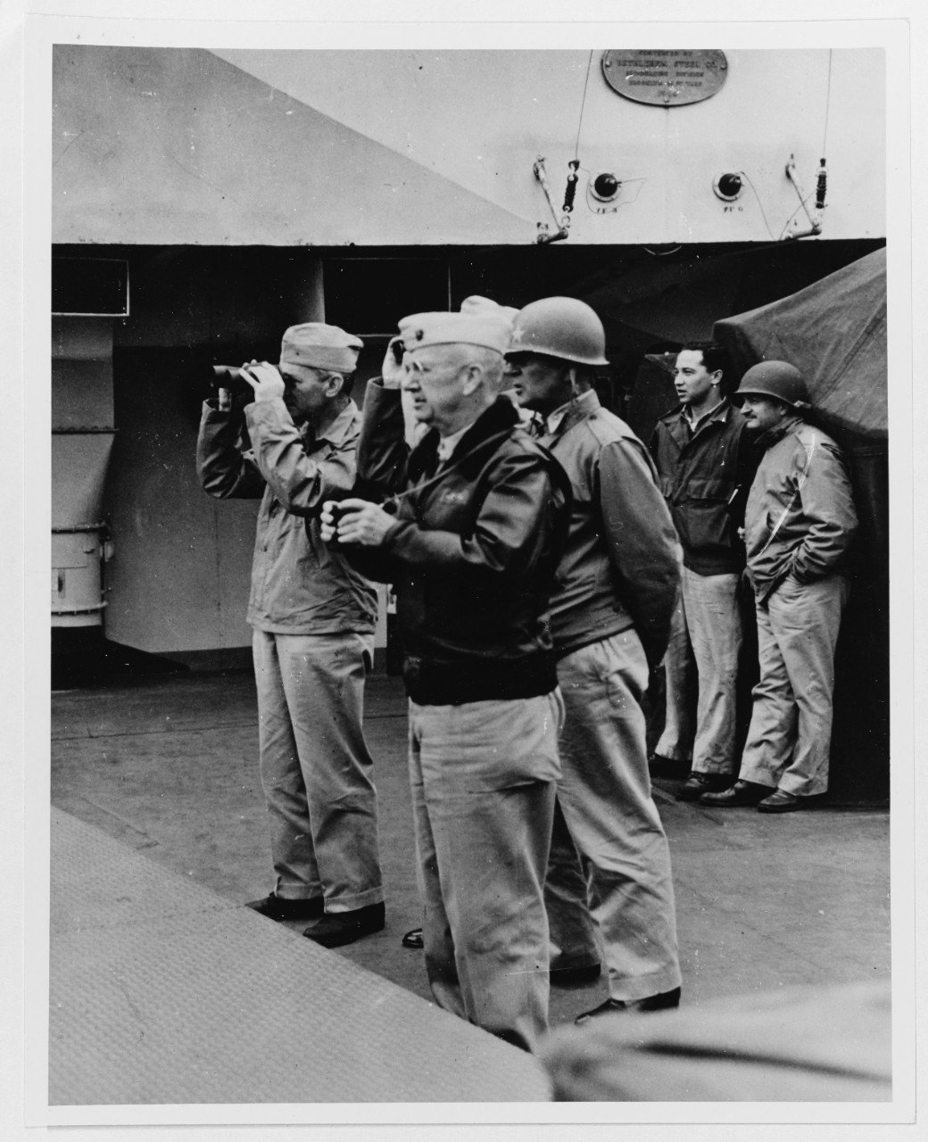 Secretary of the Navy James Forrestal and operation leaders watch invasion activities from on board USS Eldorado (AGC-11), 20 February 1945.