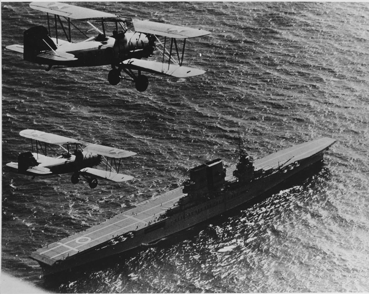 USS Saratoga (CV-3) with two O2U Corsair planes overhead