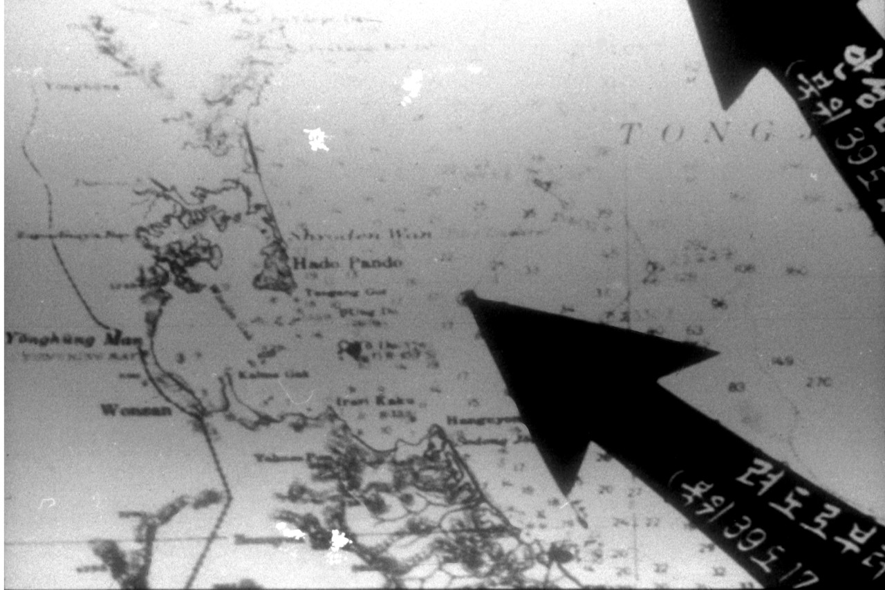 Poor quality photograph of a chart of the Wonsan area, North Korea, that was exhibited by the North Korean government to support their claim that USS Pueblo had entered that state's territorial waters. Click image to download.