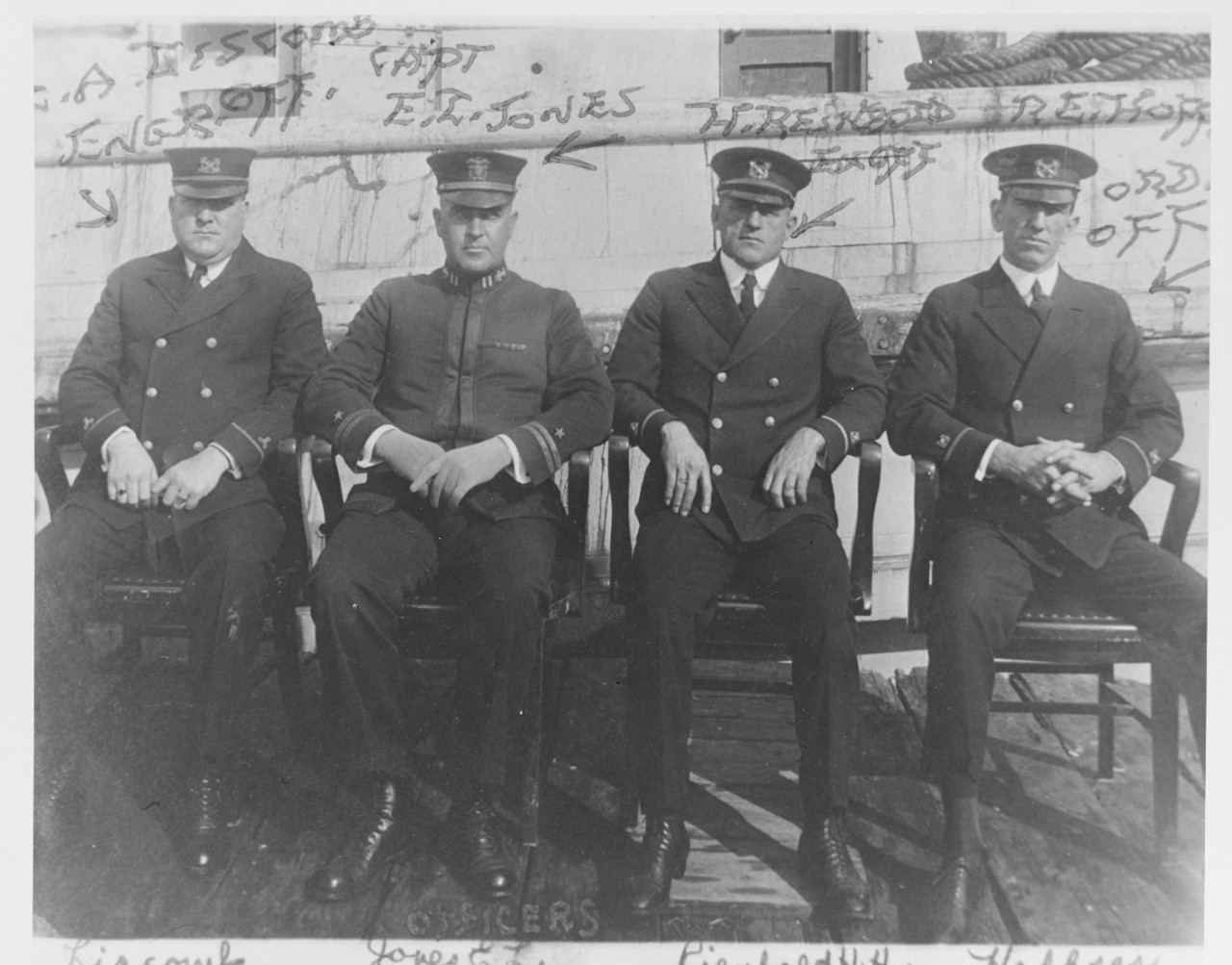 black and white photo of 4 men in naval officer uniforms identified with handwriting