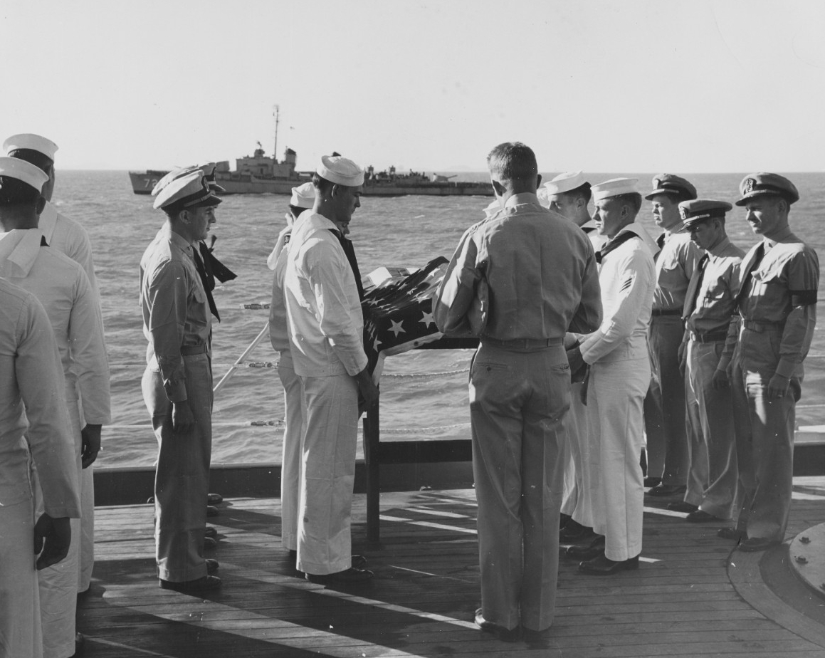 A Chaplain reads the Last Rites service as Lieutenant (Junior Grade) David H. Swenson is buried at sea from USS Toledo (CA-133), off Inchon, Korea.