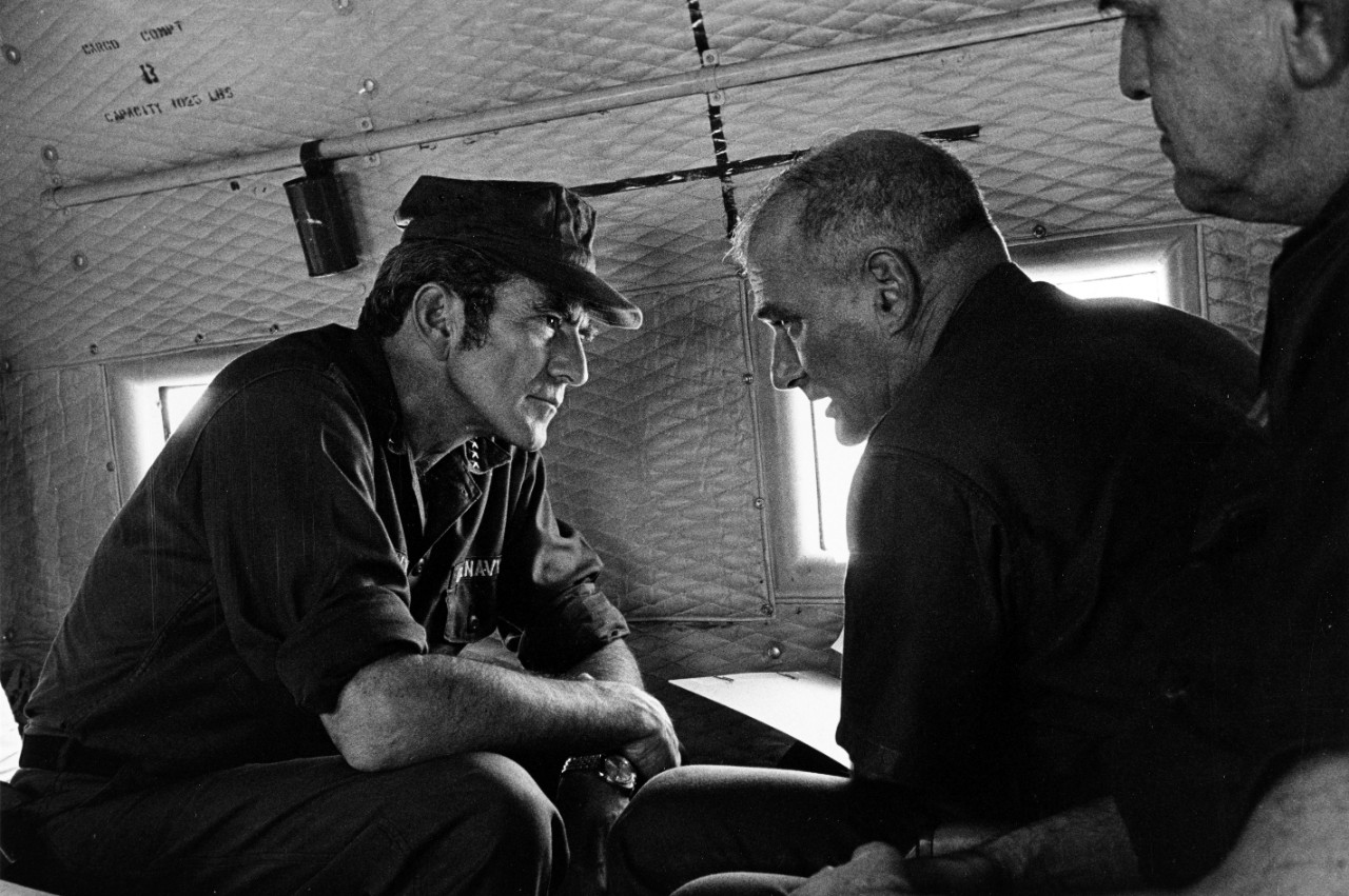 Admiral Elmo R. Zumwalt. Jr., USN, Chief of Naval Operations (left), and Rear Admiral Robert S. Salzer, USN, Commander Naval Forces Vietnam, discuss their recent visit to Nam Can Naval Base, Republic of Vietnam, as the fly to their next stop, May...