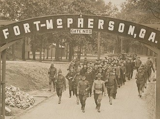 Officers and crew of the German submarine U-58, captured by the U.S.S. Fanning, passing through the gate of the prisoner-of-war camp at Fort McPherson, Georgia, under guard of U.S. Marines and soldiers, April 1918 (National Archives 31479059).