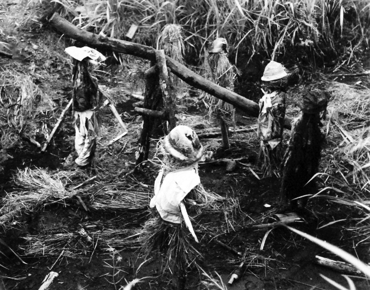 127-GW-970-71518: Battle of Cape Gloucester, New Britain, December 1943-January 1944. Dummy Japanese gun crew. To make Marines think the enemy was strong in one section on Cape Gloucester, the Japanese rigged up this scarecrow gun and crew. Photo...