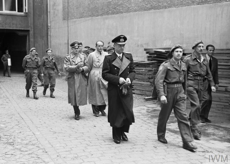 Grossadmiral Karl Doenitz is arrested in Flensburg, Germany, on 23 May 1945 by personnel of the RAF Regiment. Armaments Minister Albert Speer and Armed Forces Chief of Operations Generaloberst Alfred Jodl follow Doenitz as they are led away by ar...