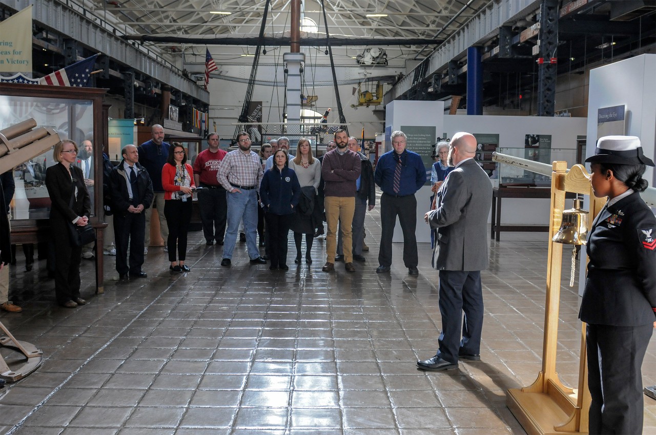 181108-N-GK939-0042 WASHINGTON (NNS) (Nov. 8, 2018) Guests gather for a Bell Ringing ceremony for the USS San Diego exhibit at the National Museum of the U.S. Navy. 