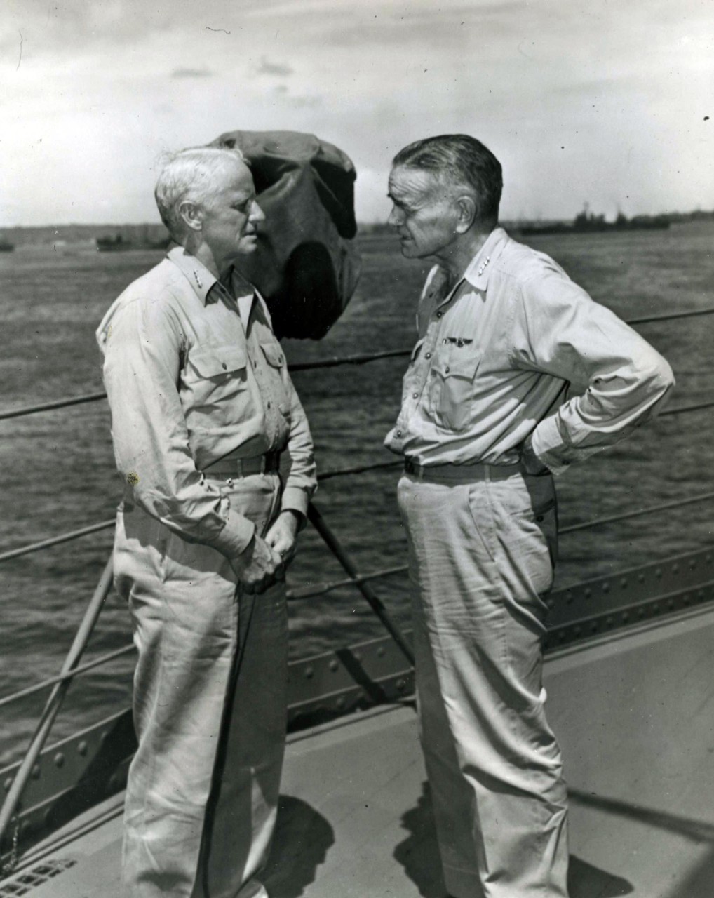 Admiral Chester W. Nimitz, USN, Commander in Chief Pacific and Pacific Ocean Areas (left), and Admiral William F. Halsey, USN, Commander, South Pacific Area and South Pacific Force, confer aboard USS Curtiss (AV-4) at "Button" Naval Base, Espirit...