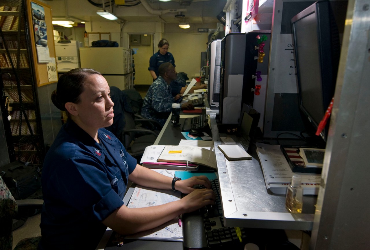 Logistics Specialist 1st Class Martha Mayoral, assigned to the Maintenance Support Center aboard the Nimitz-class aircraft carrier USS Carl Vinson (CVN 70), enters information on the Organizational Management Maintenance System-Next Generation co...