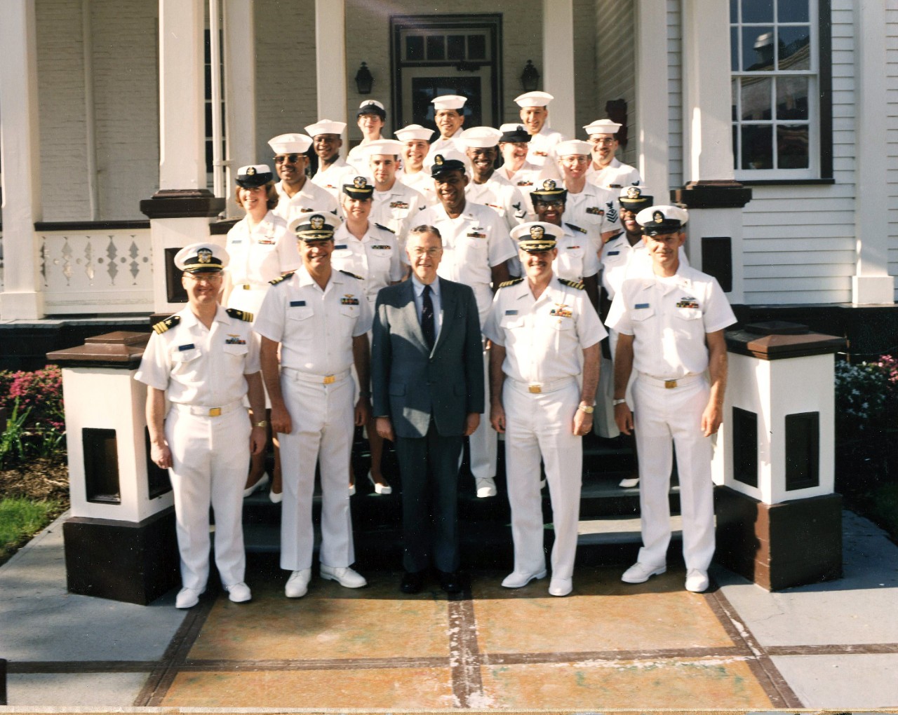Dr. Dean Allard pictured (center) on the Washington Navy Yard in an undated photo with several Sailors in their dress whites. Dr. Allard was the Naval History Director from 1989-1995. 