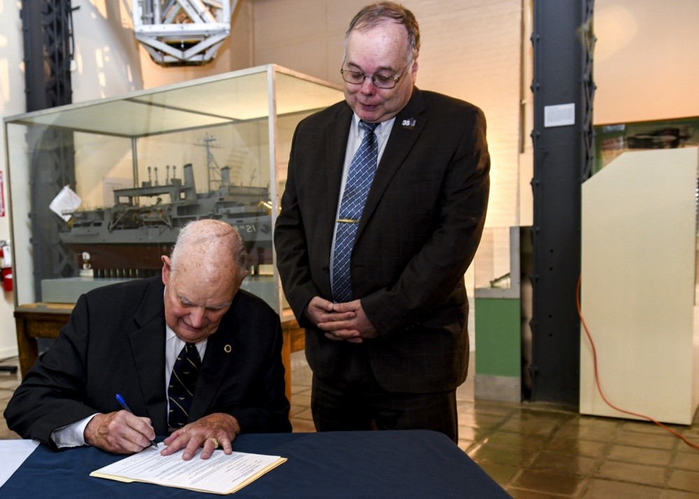 WASHINGTON NAVY YARD (Oct. 15, 2019) Retired Rear Adm. Robert Fountain signs a document granting four artifacts from USS Scorpion (SSN 589) to Naval History and Heritage Command (NHHC) as witnessed by retired Rear Adm. Samuel Cox, director of NHH...