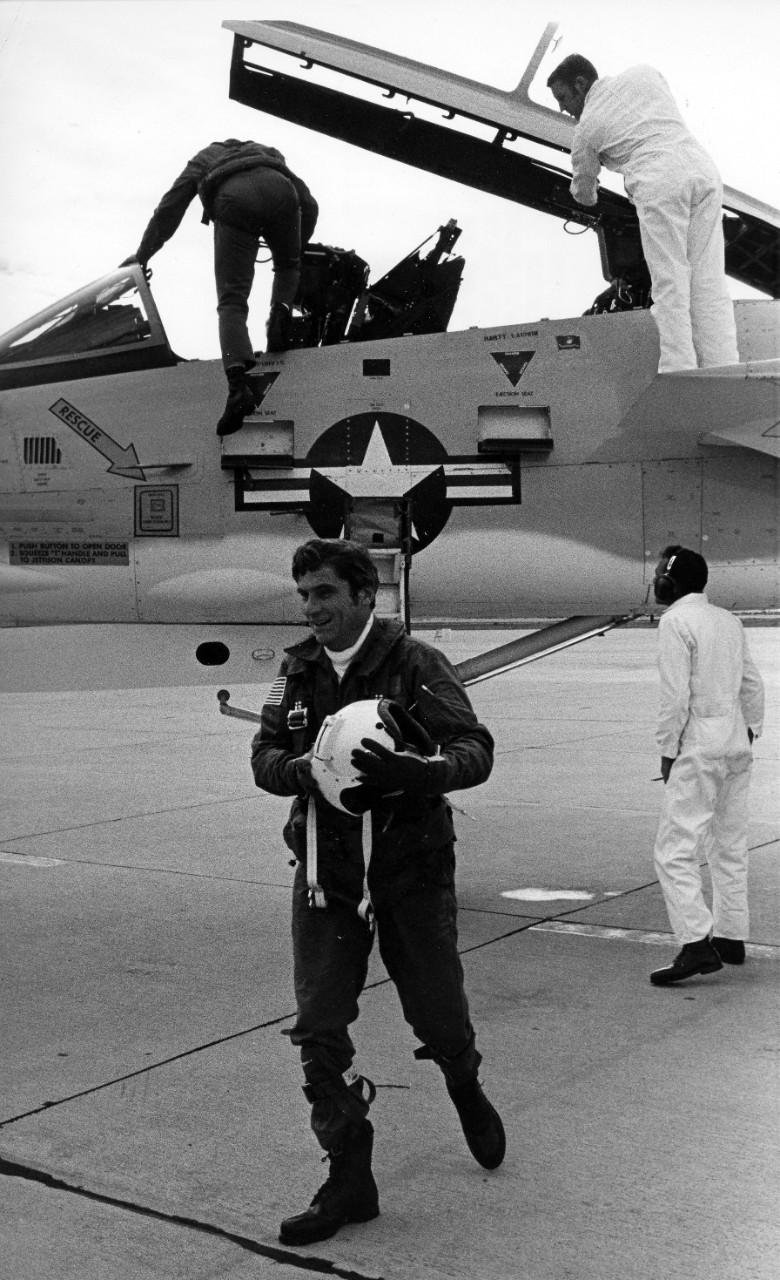 Naval Air Station Miramar, CA - the Honorable John W. Warner, Secretary of the Navy, walks away from the F-14A Tomcat fighter aircraft which brought him to the station for the establishment ceremony for fighter squadrons one and two (VF-1 and VF-...