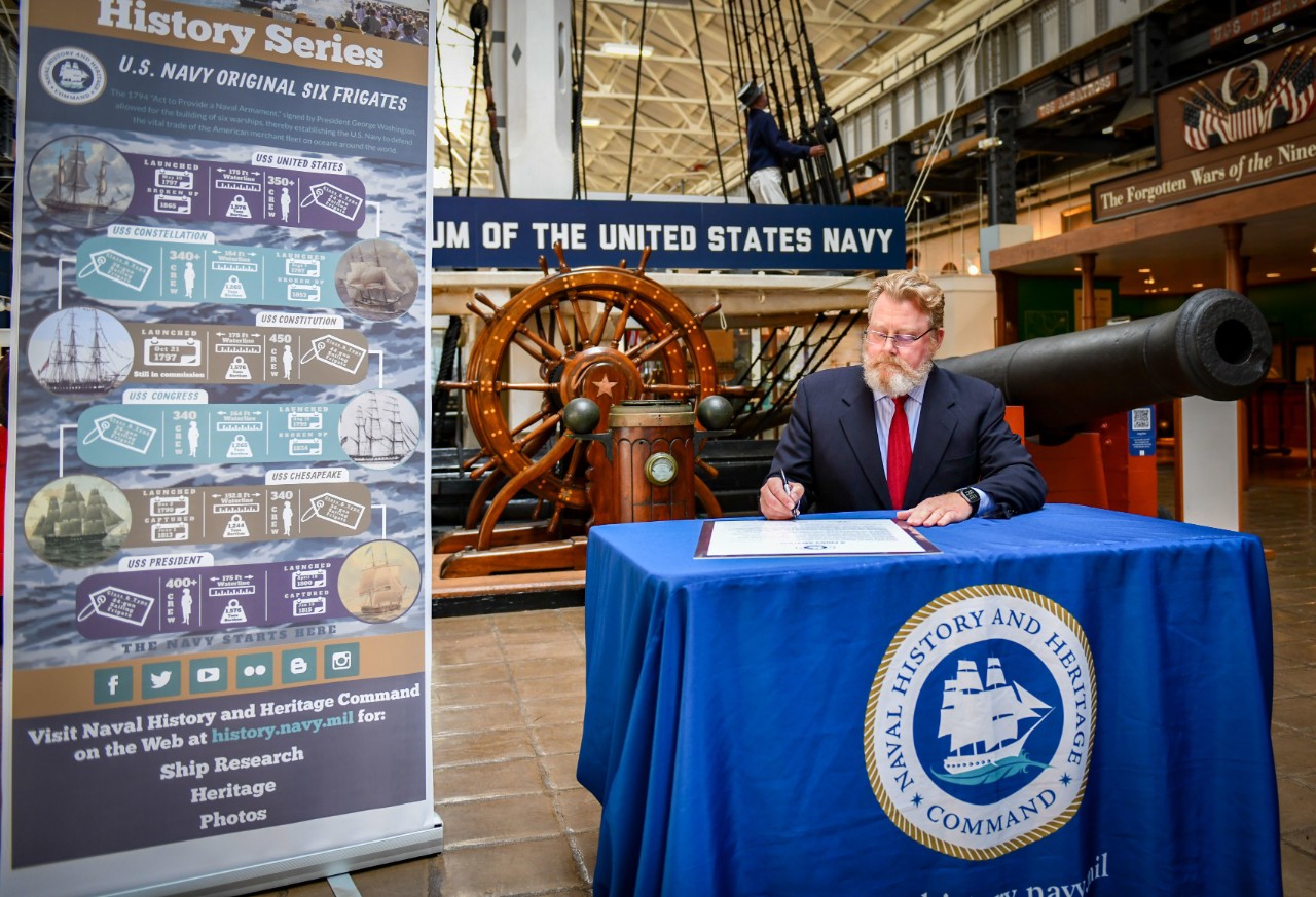 Patrick C. Burns, Deputy Director of Naval History and Heritage Command, signs a proclamation at the National Museum of the U.S. Navy, which proclaims May 10, 2022, to be U.S. Navy Original Six Frigates Day. NHHC commemorated the 225th anniversar...