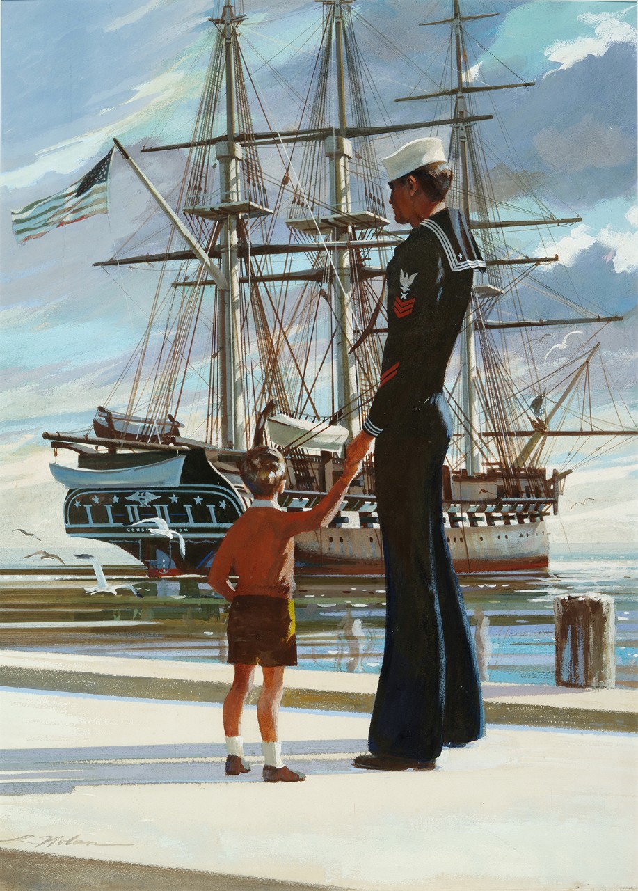 A sailor holds the hand of a little boy while both look at USS Constitution