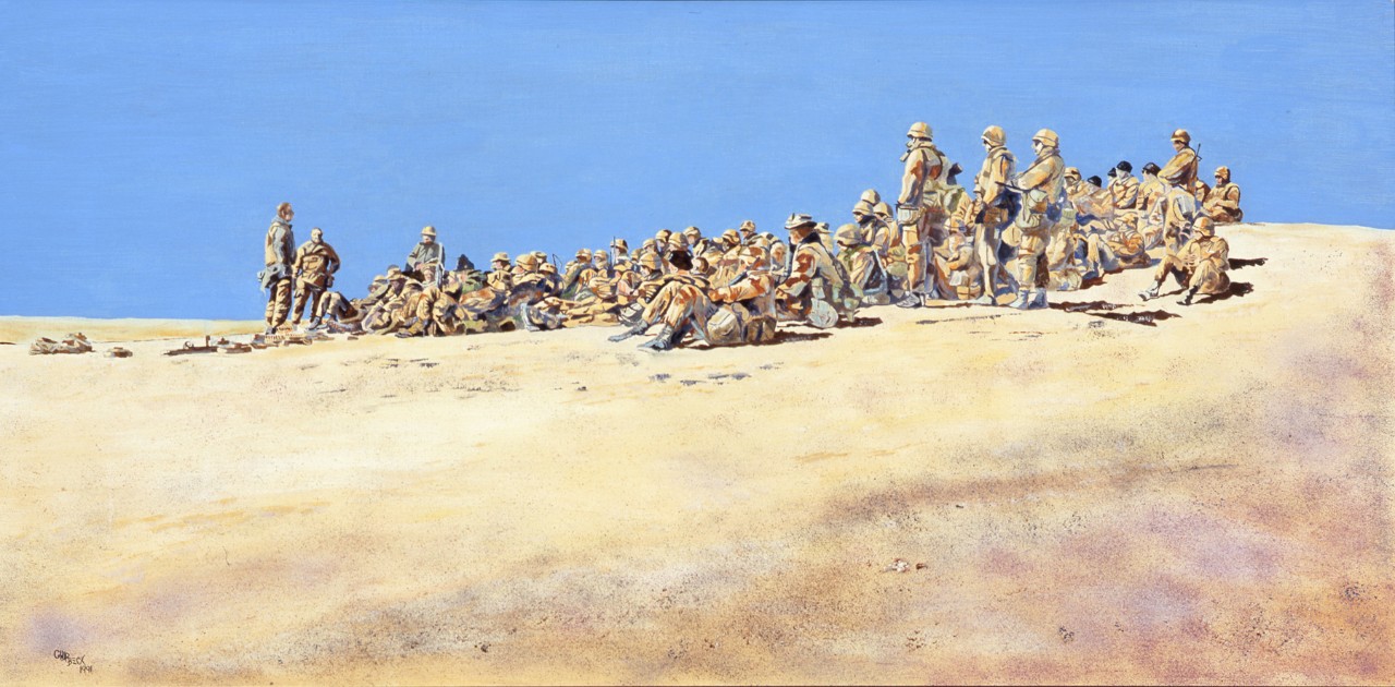 A group of Marines are seated on a hill side