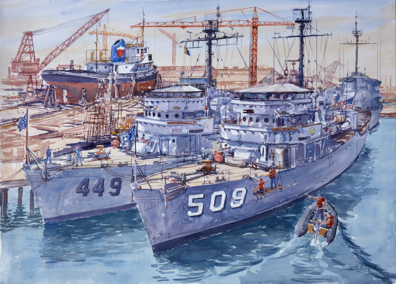 Three minesweepers next to a pier with another ship in the background