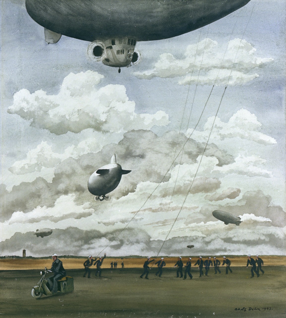 A ground crew grabs the lines from the blimp