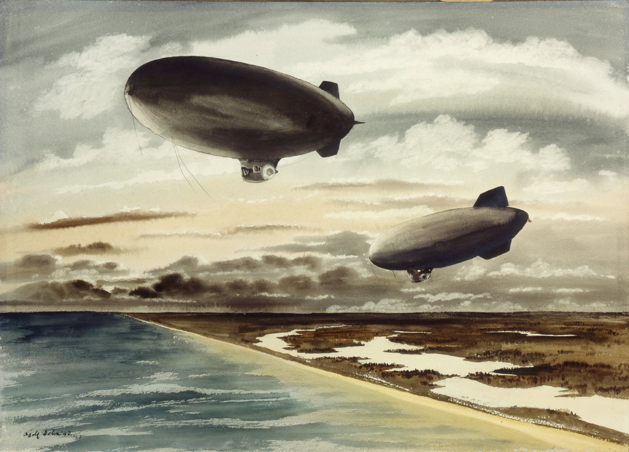 Two blimps flying over the coast