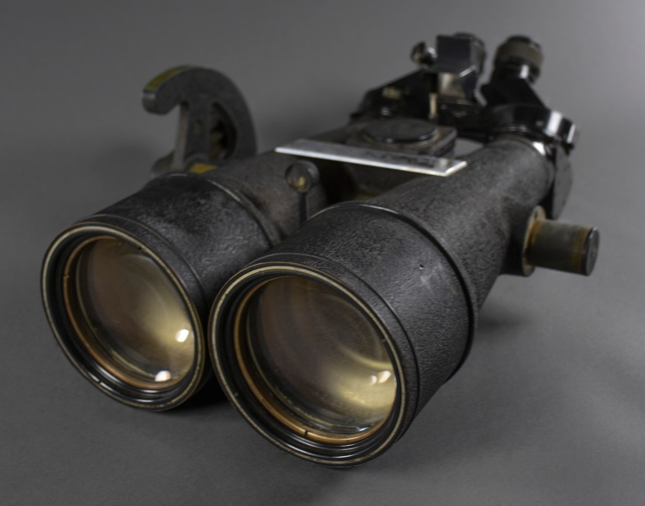 Black Big Eye Binoculars with presentation plaque on top. Japanese characters on various sections of the binoculars 
