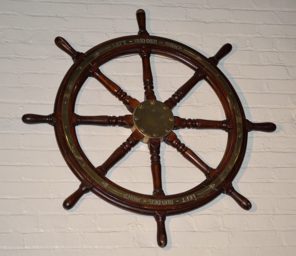 Eight spoked ship wheel with brass rim from the USS Pensacola
