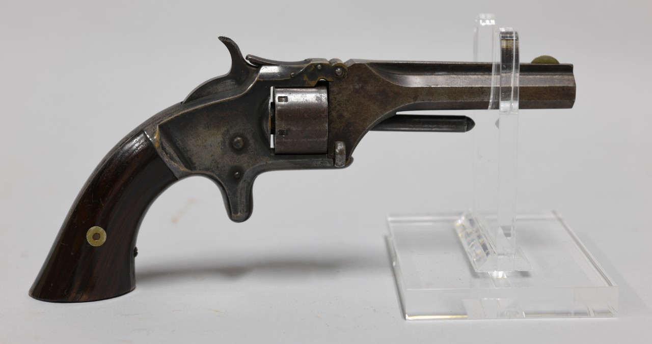 Obverse view of .22 caliber Model No. 1 Smith & Wesson revolver. Metal frame with polished wood grip.