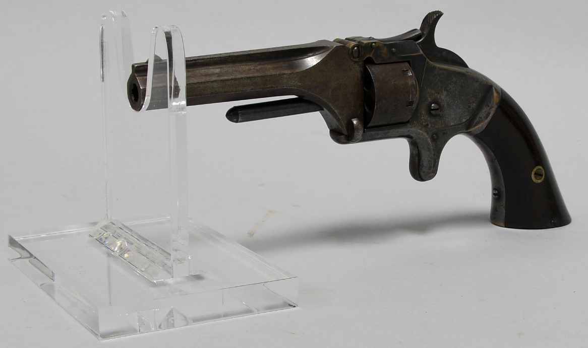 Front quarter view of .22 caliber Model No. 1 Smith & Wesson revolver. Metal frame with polished wood grip. Hexagonal barrel.    