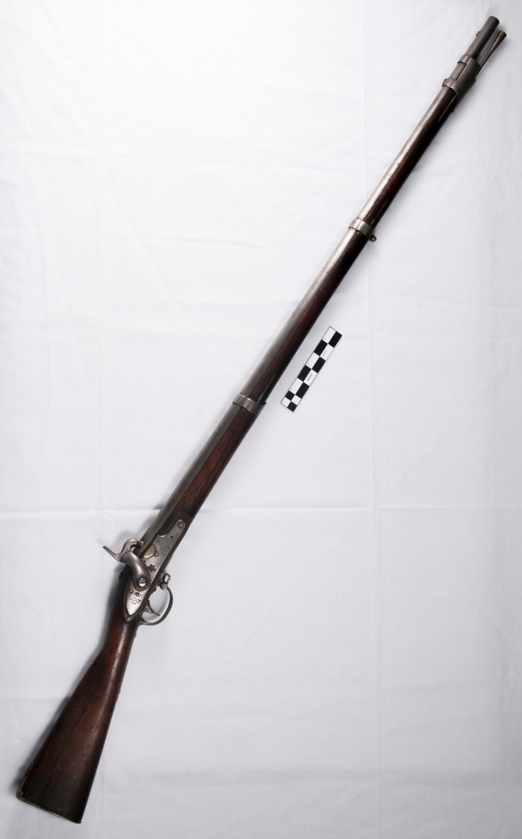 A smoothbore, .69 caliber musket converted from flintlock to percussion ignition. The musket has a 42-inch long barrel held to the full-length stock by two bands and a front band/nose cap.