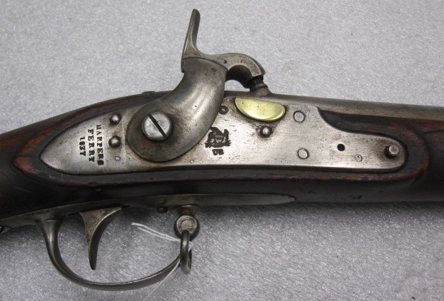 The iron lock plate is held in place by two screws and an L-shaped left side plate. The tail of the lock is marked “HARPERS/FERRY/1837” and the national eagle above “US” forward of the hammer. The tang of the iron butt plate is also marked “US”. ...