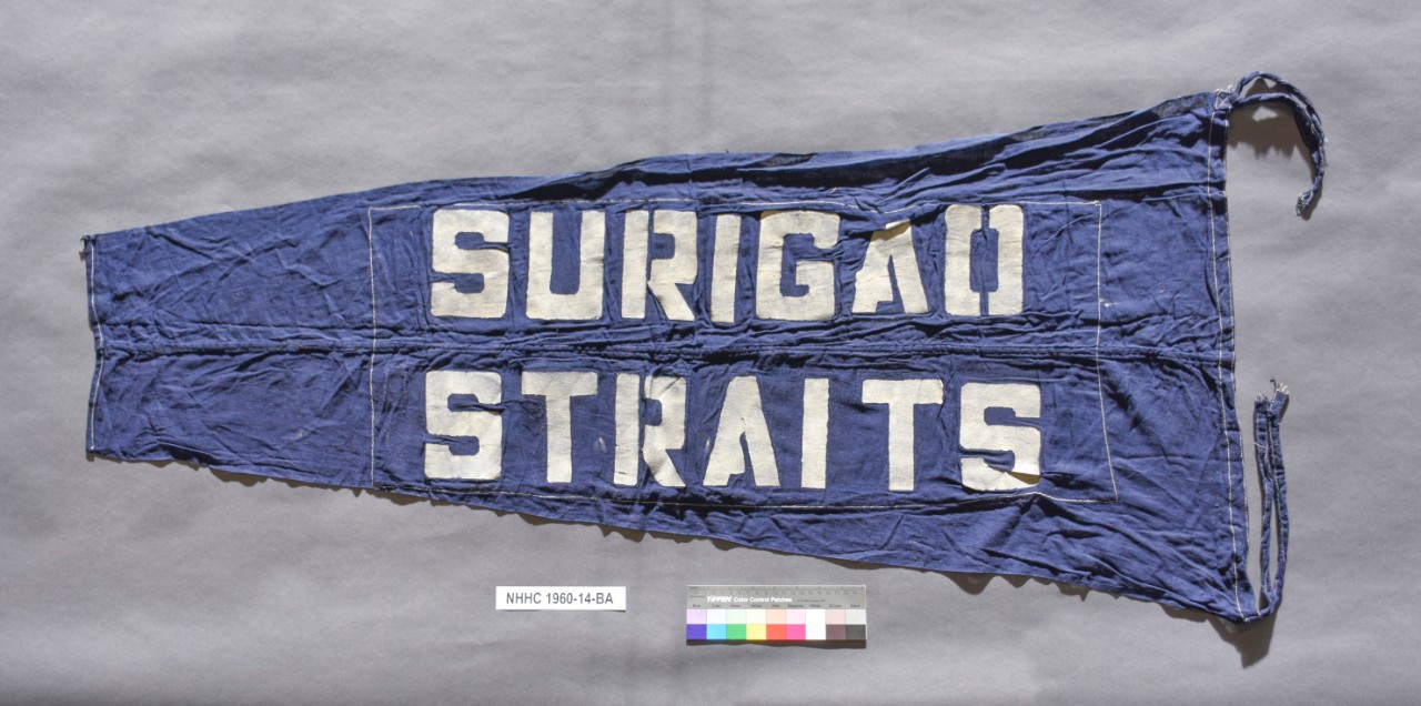 Blue Pennant with streamers at either end of hoist. "Surigao Straits" written in white letters